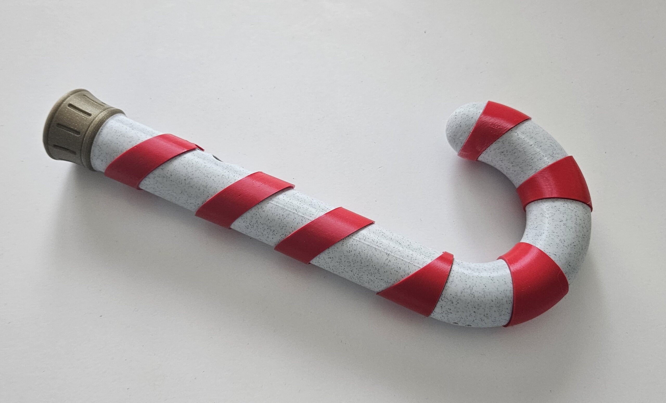 raw photo of a candy cane functional lightsaber made by mystery makers